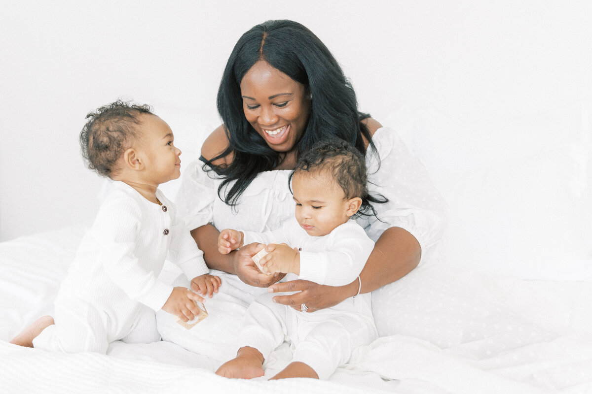 African american woman with her twin one year old boys in studio  for family pictures
