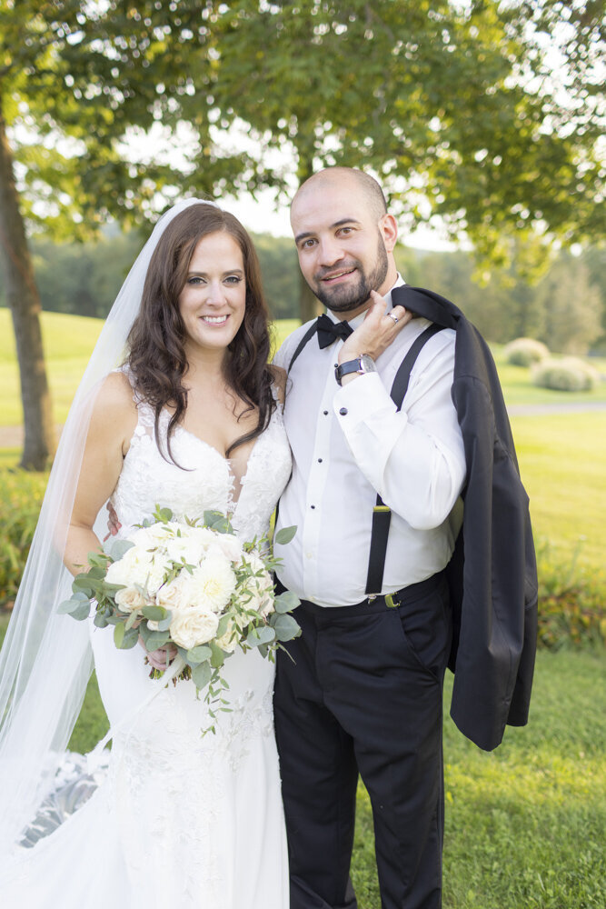 bride and groom smiling together for portrait - candlelight farms inn wedding