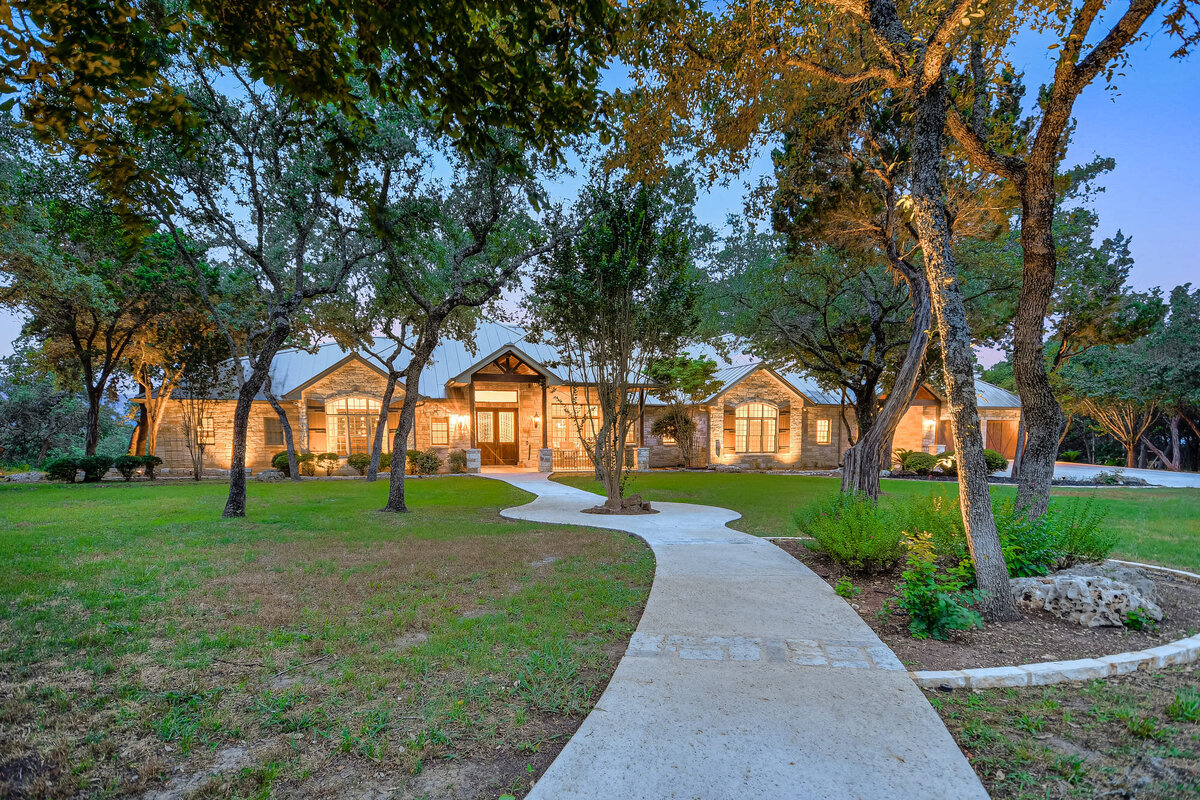 front of large Texans home