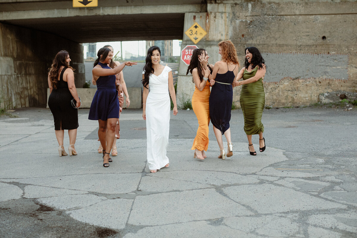a-bride-and-her-bridal-party-walking-outside-the-orange-art-gallery-1
