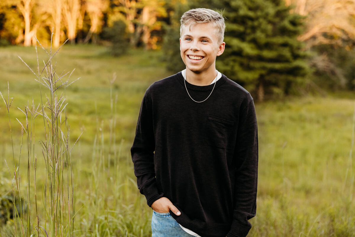blonde teen boy walking with his hand in his jeans for senior session