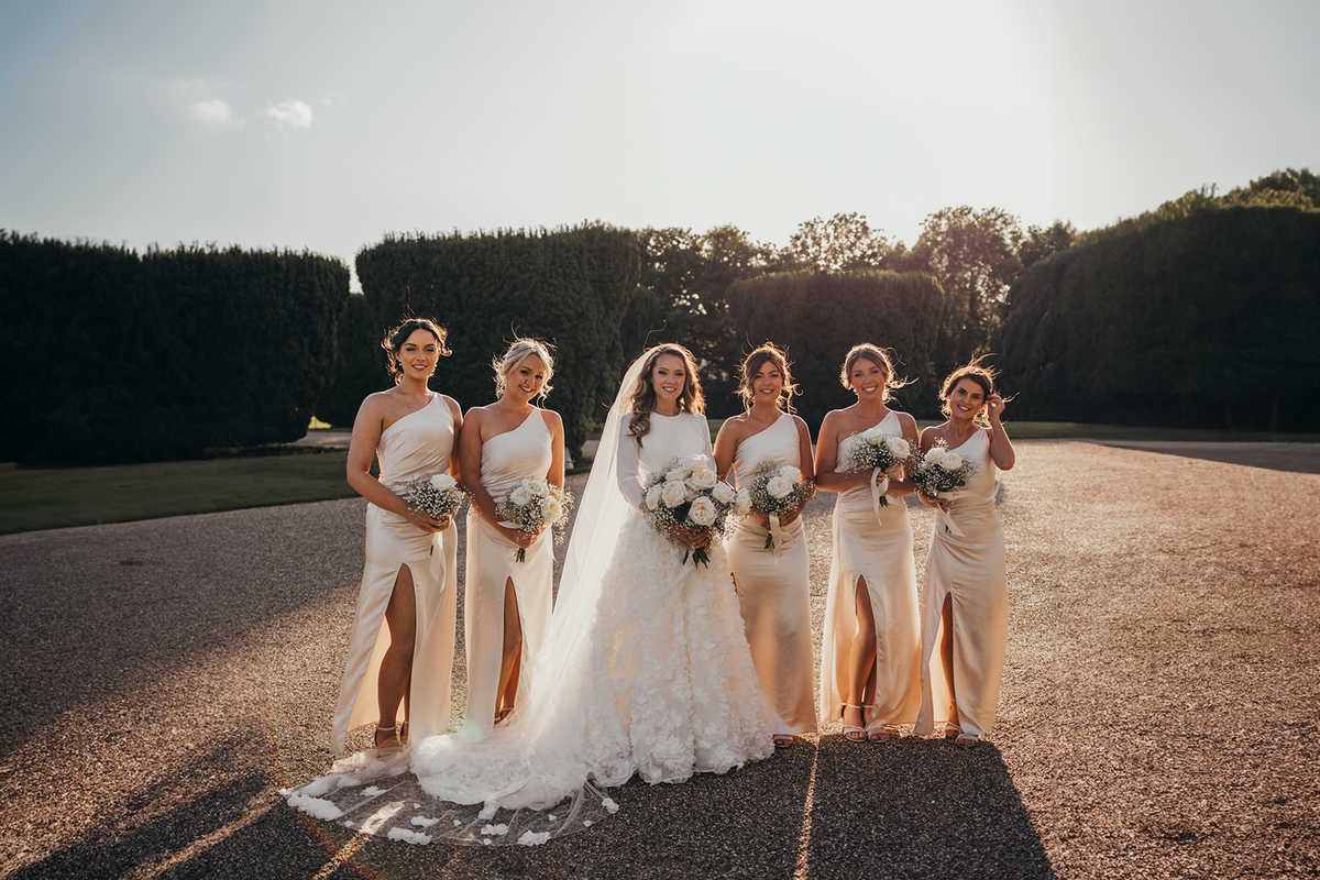 bride poses with her bridesmaids