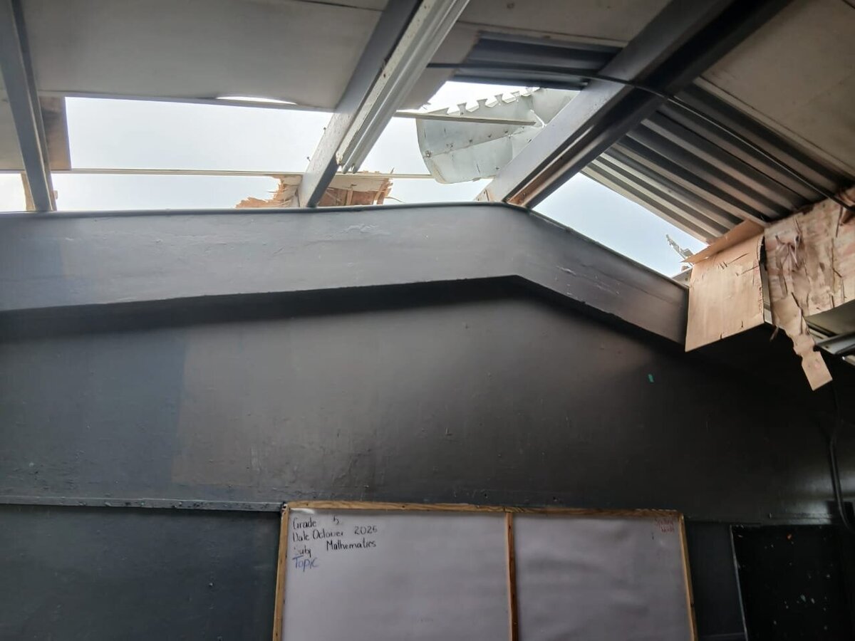 Interior view of broken roof panels and exposed beams inside Barbary Hall Primary’s classrooms.