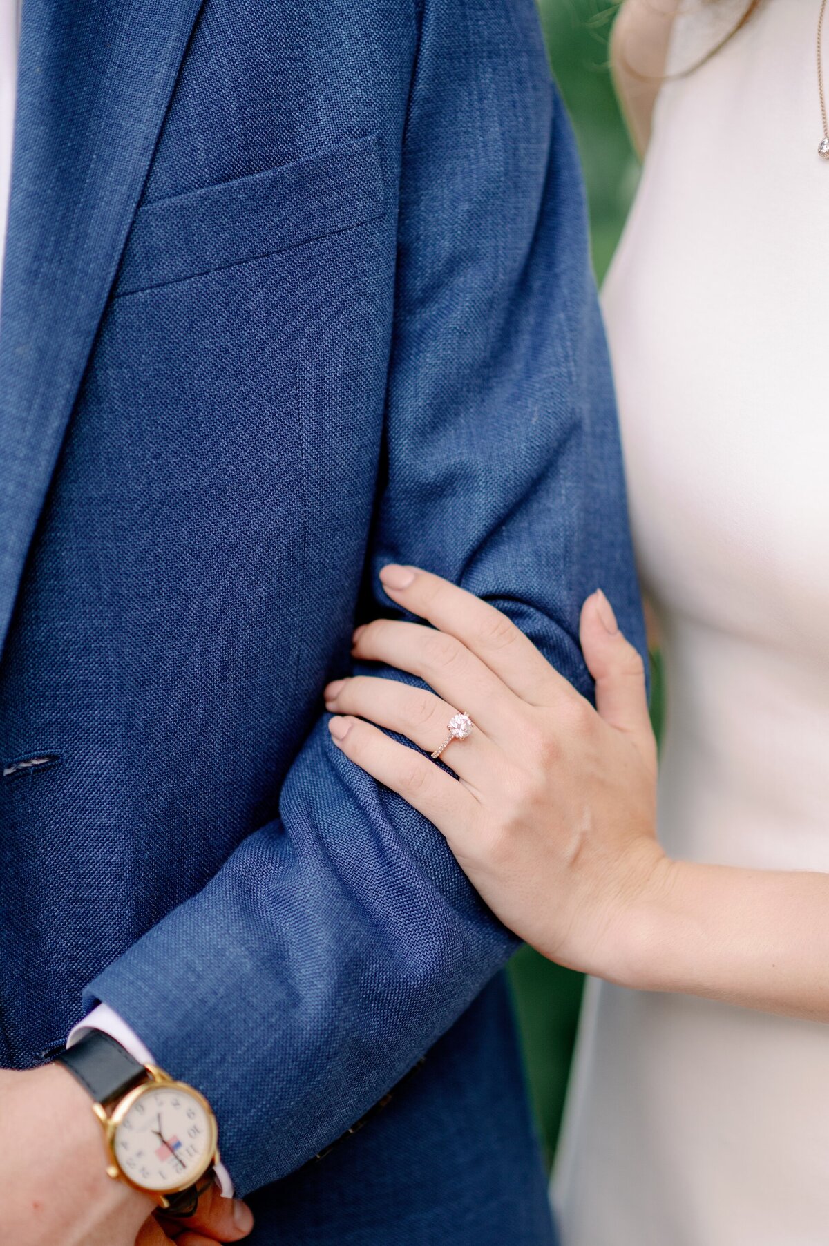 engaged woman's hand resting on her fiance's arm