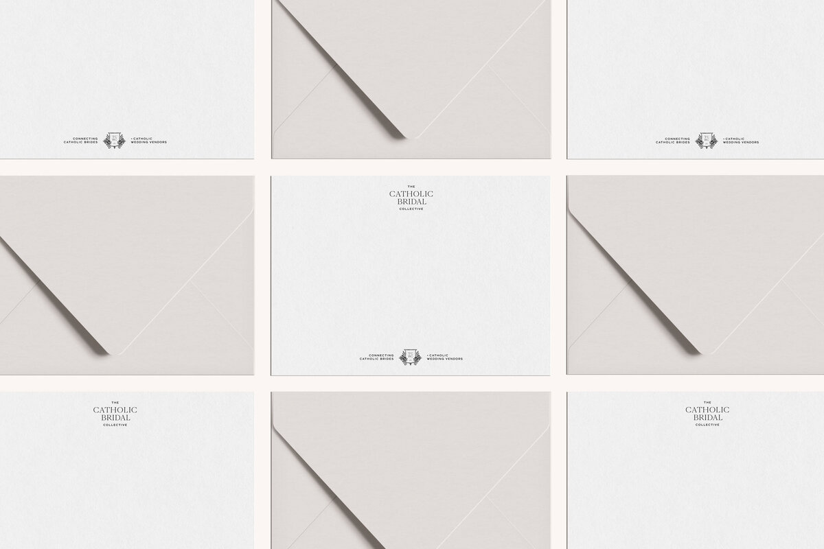 a mockup of a black logo on white stationery with beige envelopes