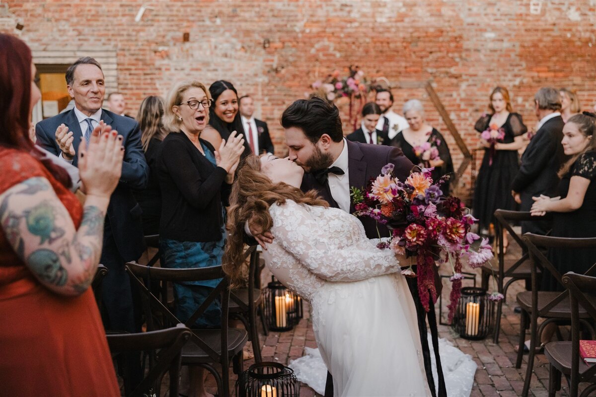 Groom dipping a bride for a kiss