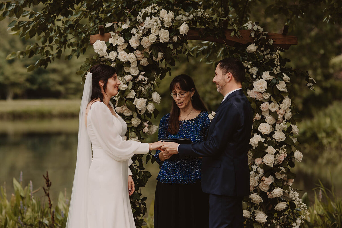 A couple holding hands as they say their vows 