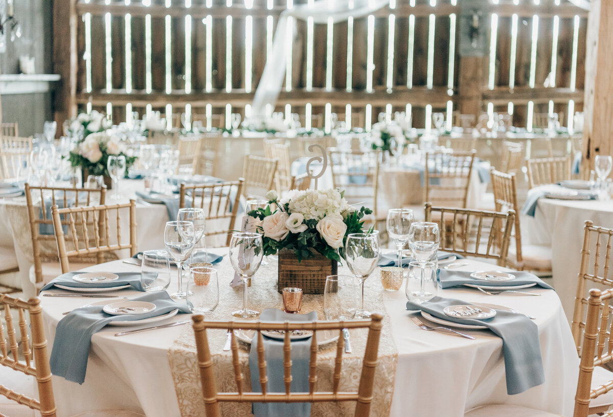 Elegant white, blue, and gold themed barn wedding reception