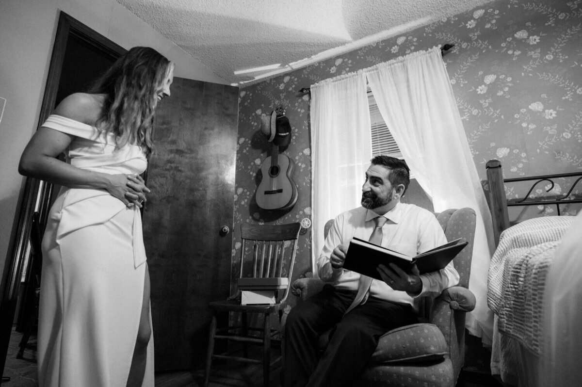 groom-looks-at-boudoir-book