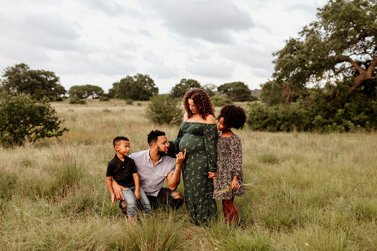 Maternity session of a pregnant woman with her family at sunset, photographed by San Antonio family photographer Sara James.