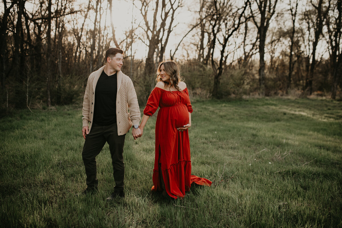 Expecting couple poses in woodland outdoor setting during photography session with maternity photographer, Cameron Fox, of Foxc Photography.