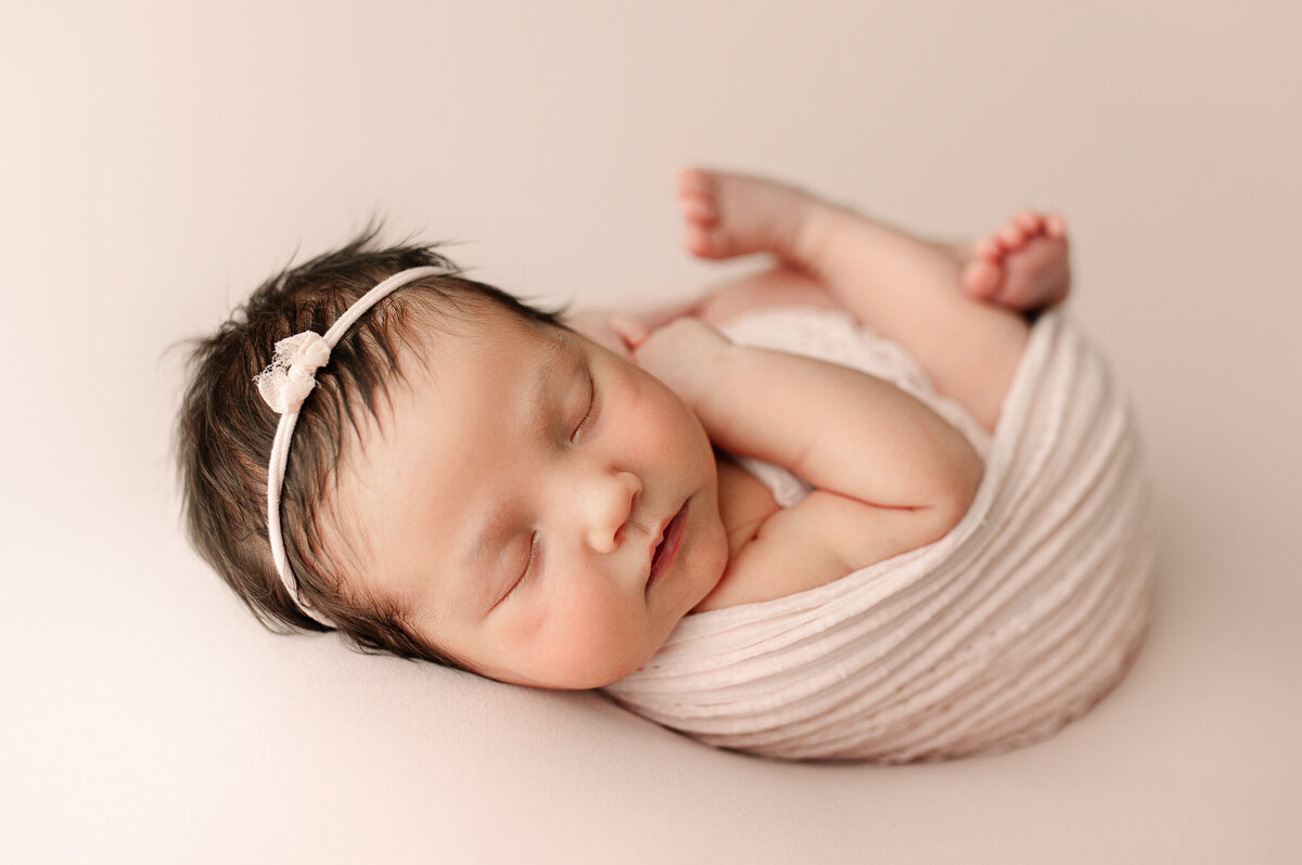Newborn with dainty headband luxury natural light photography