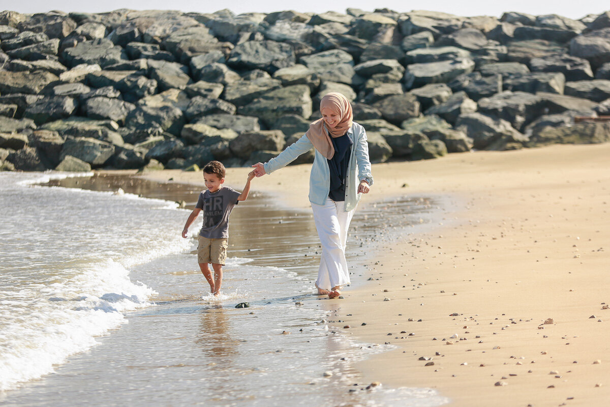 muslim-mom-with-her-son-running-on-the-beach