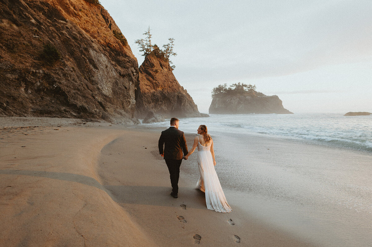 elopement couple walking along Oregon coast