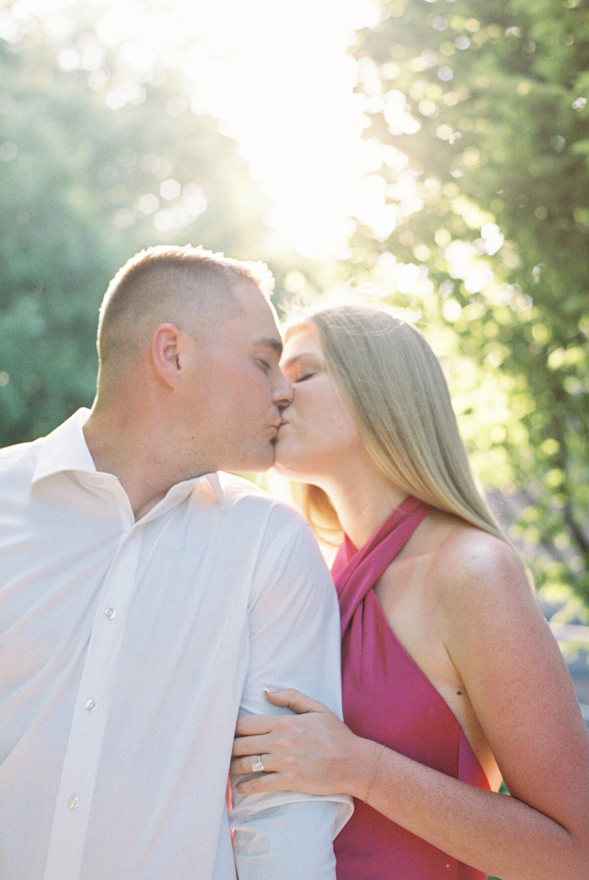 Sunset kiss in Columbus park, engagement photo by Philly-based wedding photographer.
