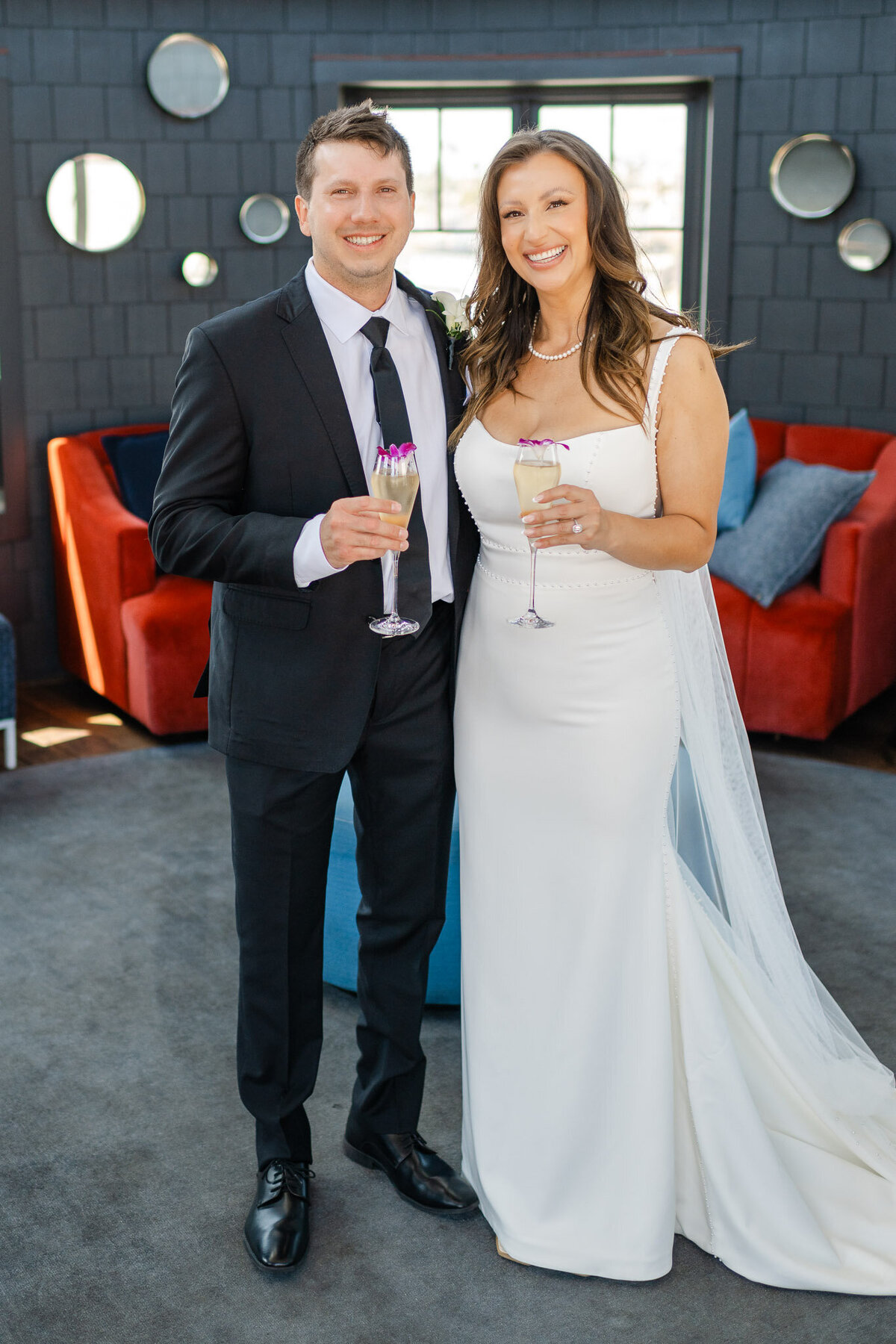 Bride and groom toast with champagne, celebrating their wedding at Lido House, Newport Beach