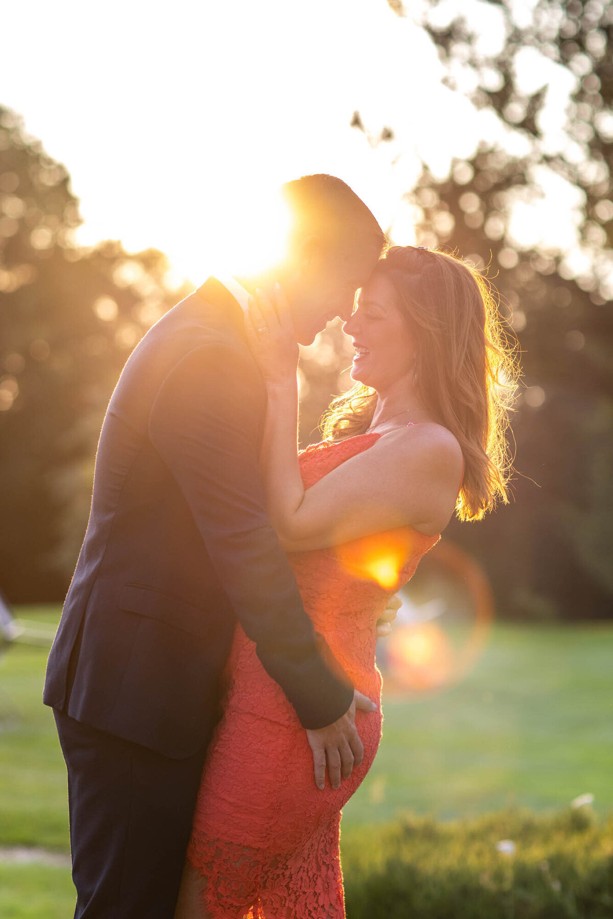 Couple embracing at dusk in outdoor engagement session