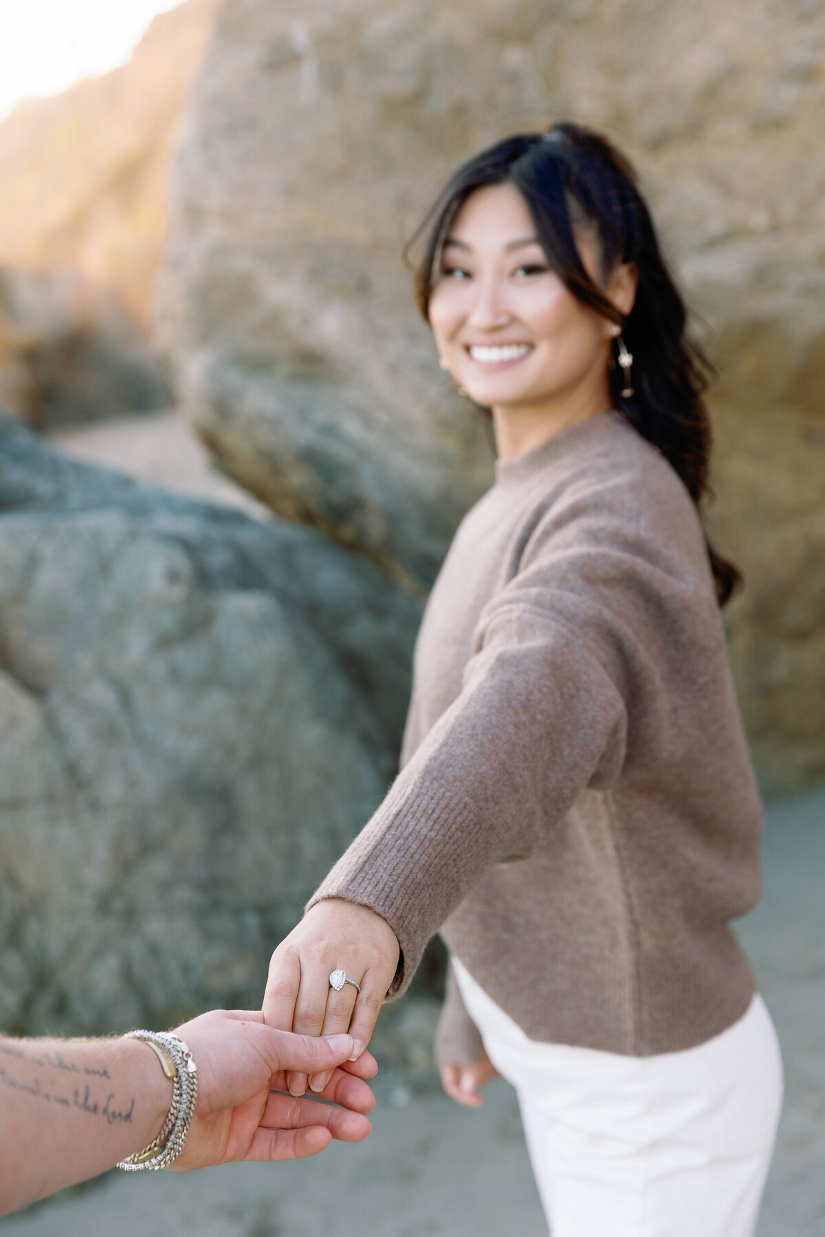 A woman reaching out towards another person's hand