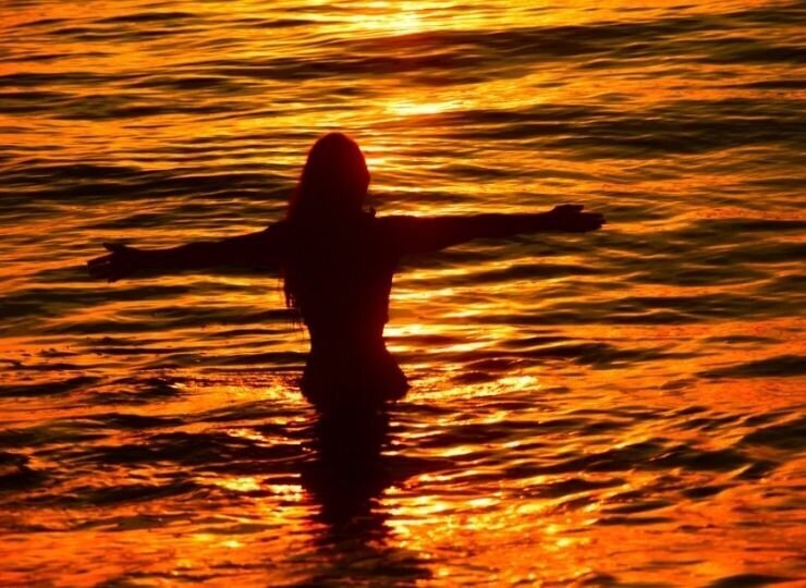 beautiful-women-beach-sunrise-florida-water-bright-orange