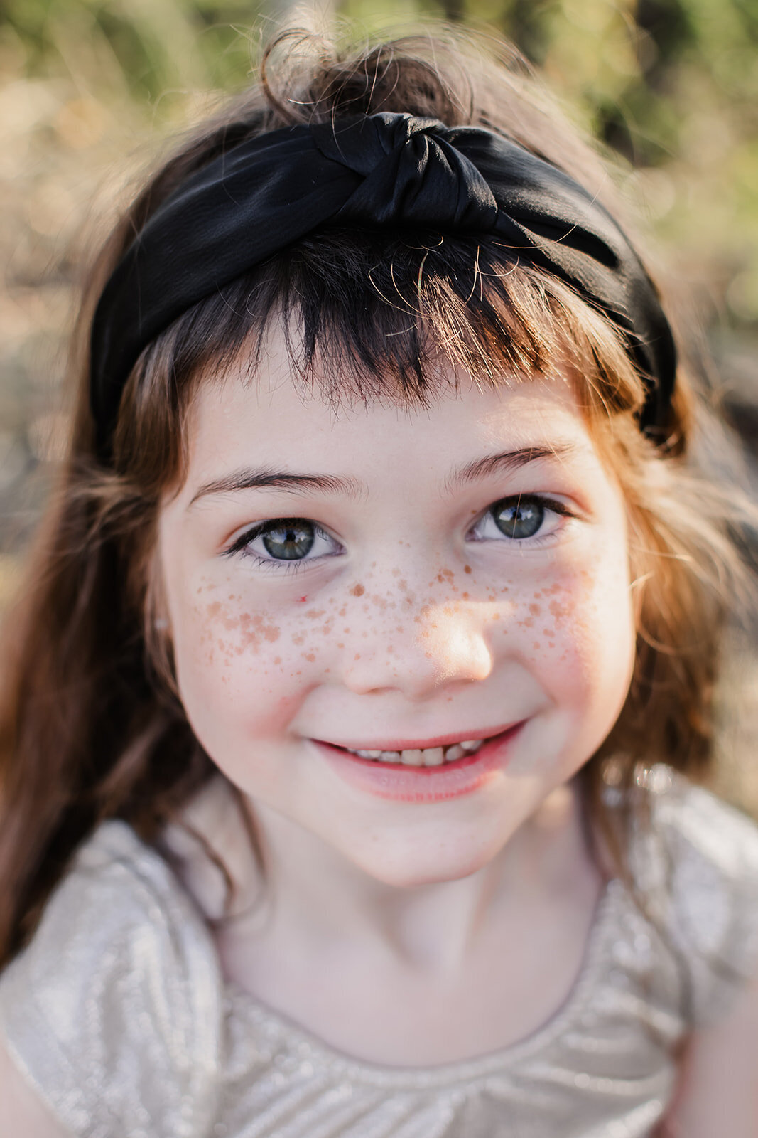 A freckled face daughter smiling.
