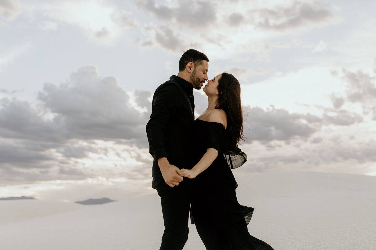 engaged couple kissing at white sands national park