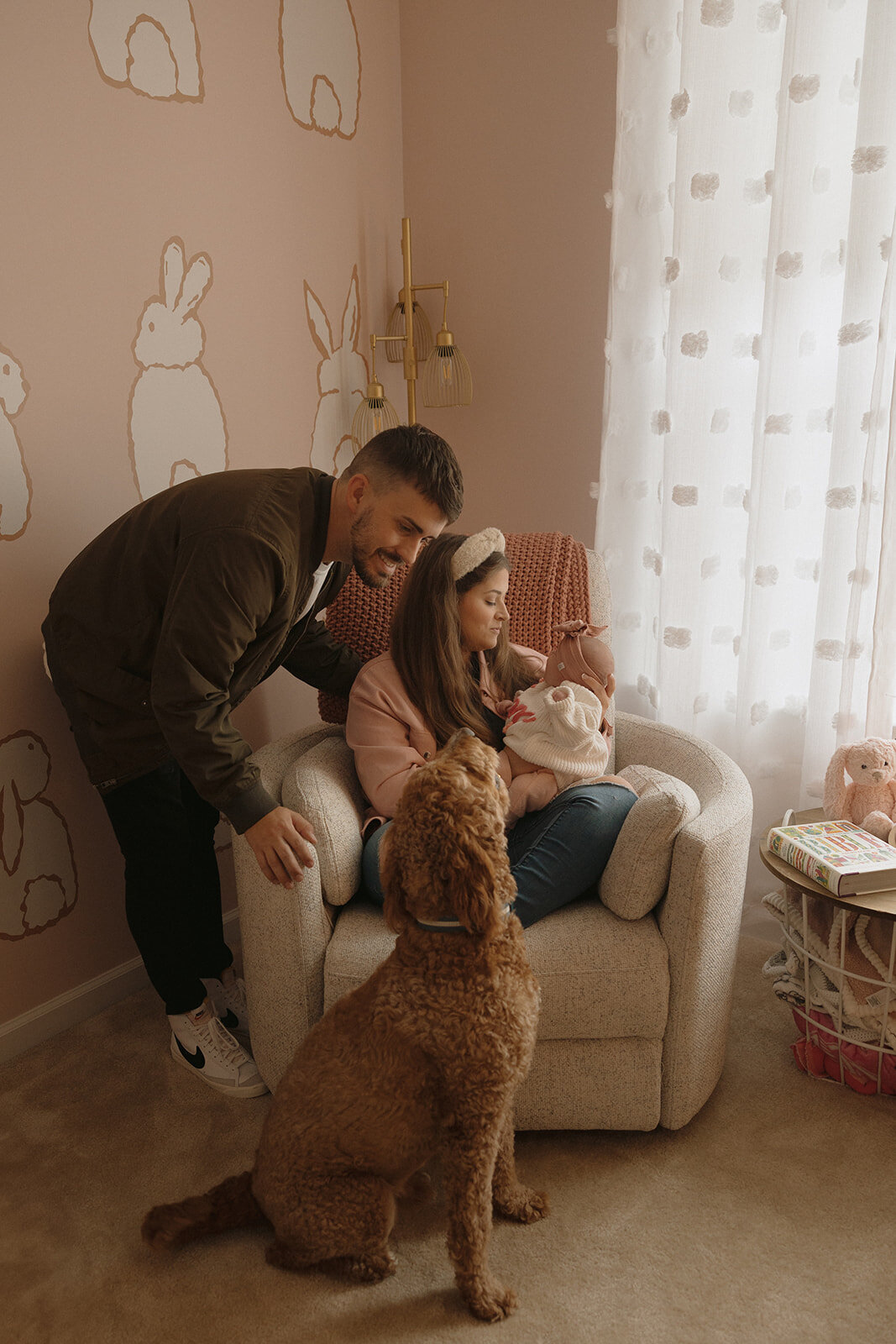 couple posing in their newborn's nursery during their photoshoot with RVA newborn photographer, Three Bridge Photography