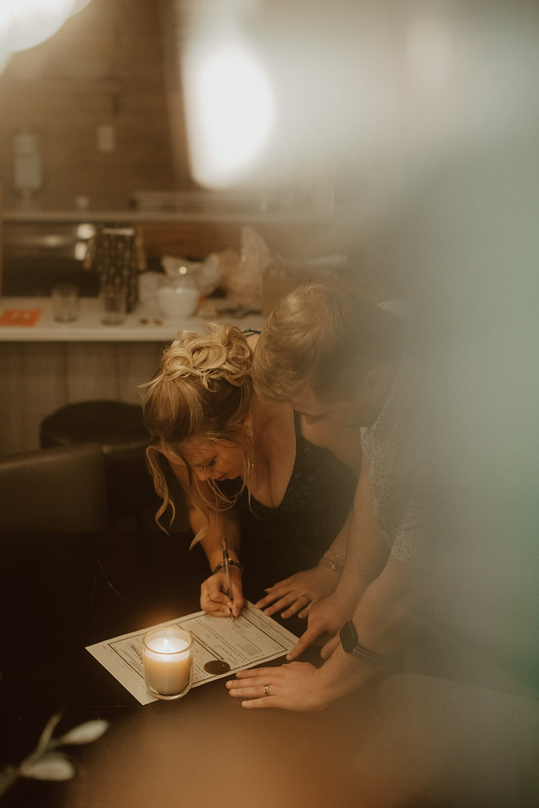man and woman signs marriage license in Breckenridge Colorado