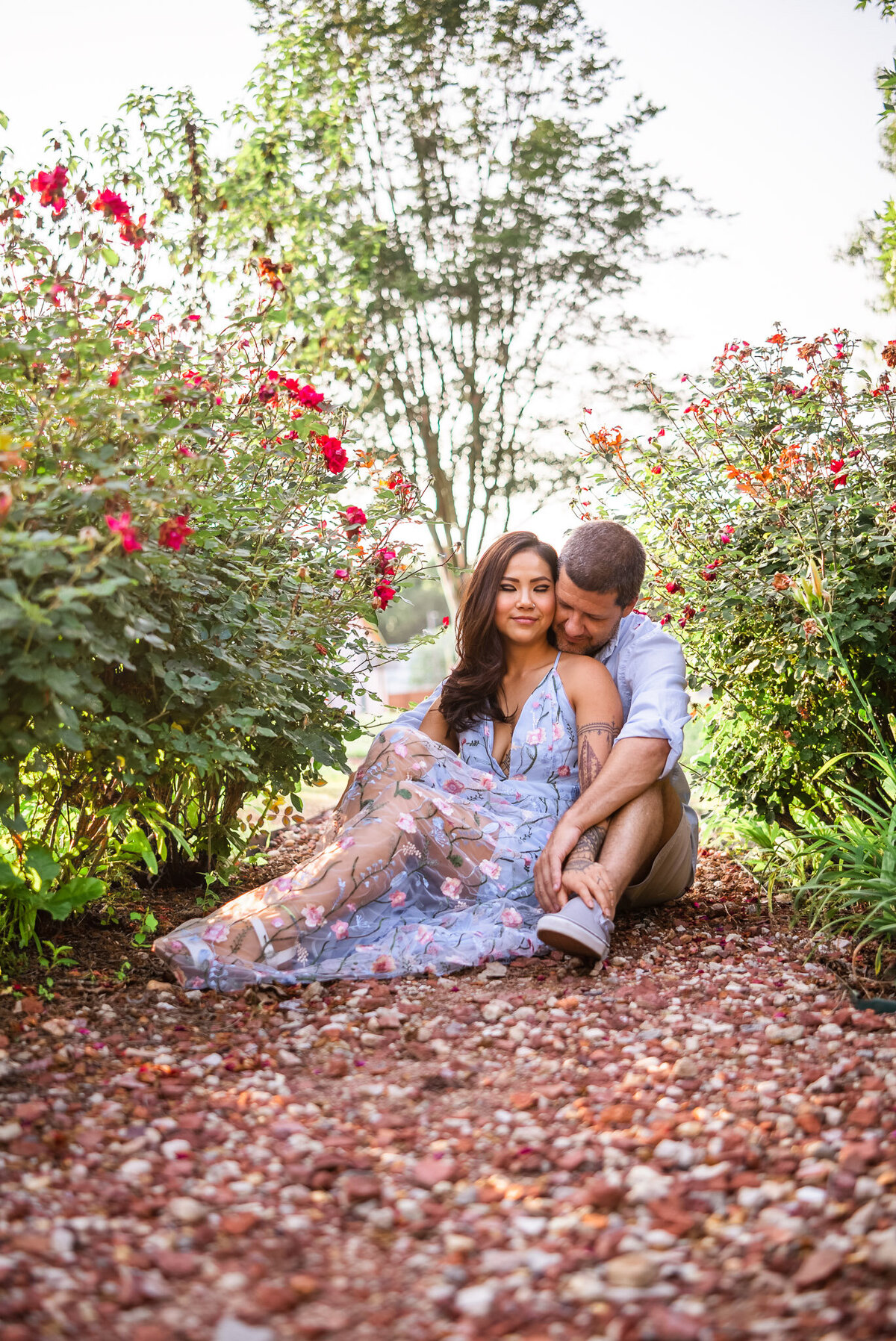 woman and boyfriend cuddle in the roses