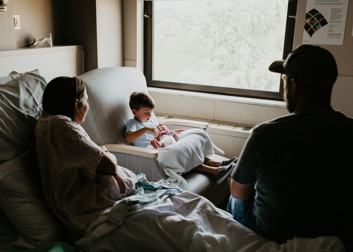 A family sits in a hospital room with their newborn baby in Pittsburgh.