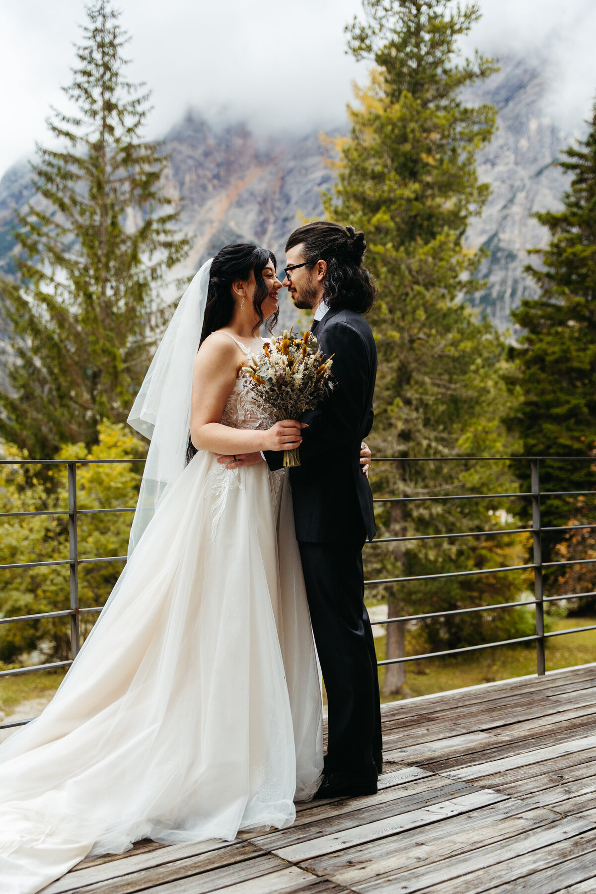 Couple standing together by Lake Braies with mountains