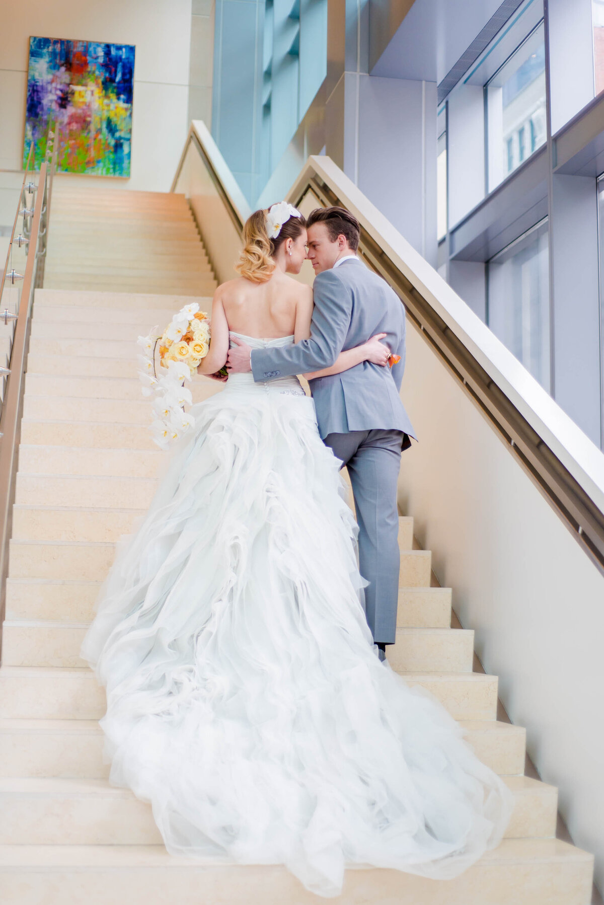 married couple posing for photo on fairmont hotel steps