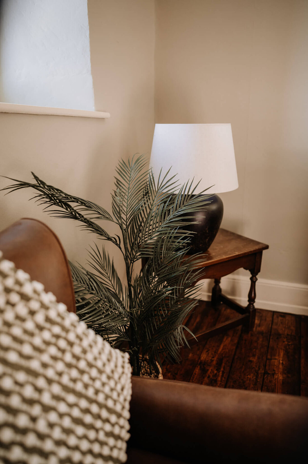 Stylish lamp and plant decor detail in the games room at Caswell House
