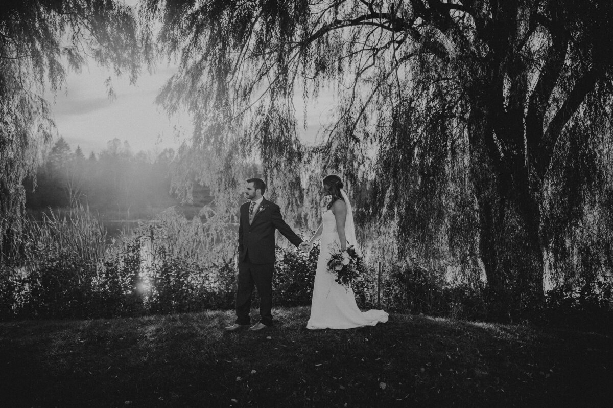 Bride and groom walking in front of the 18th hole at The Bog