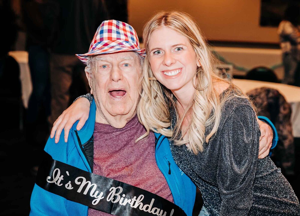 90 year old birthday boy with his granddaughter