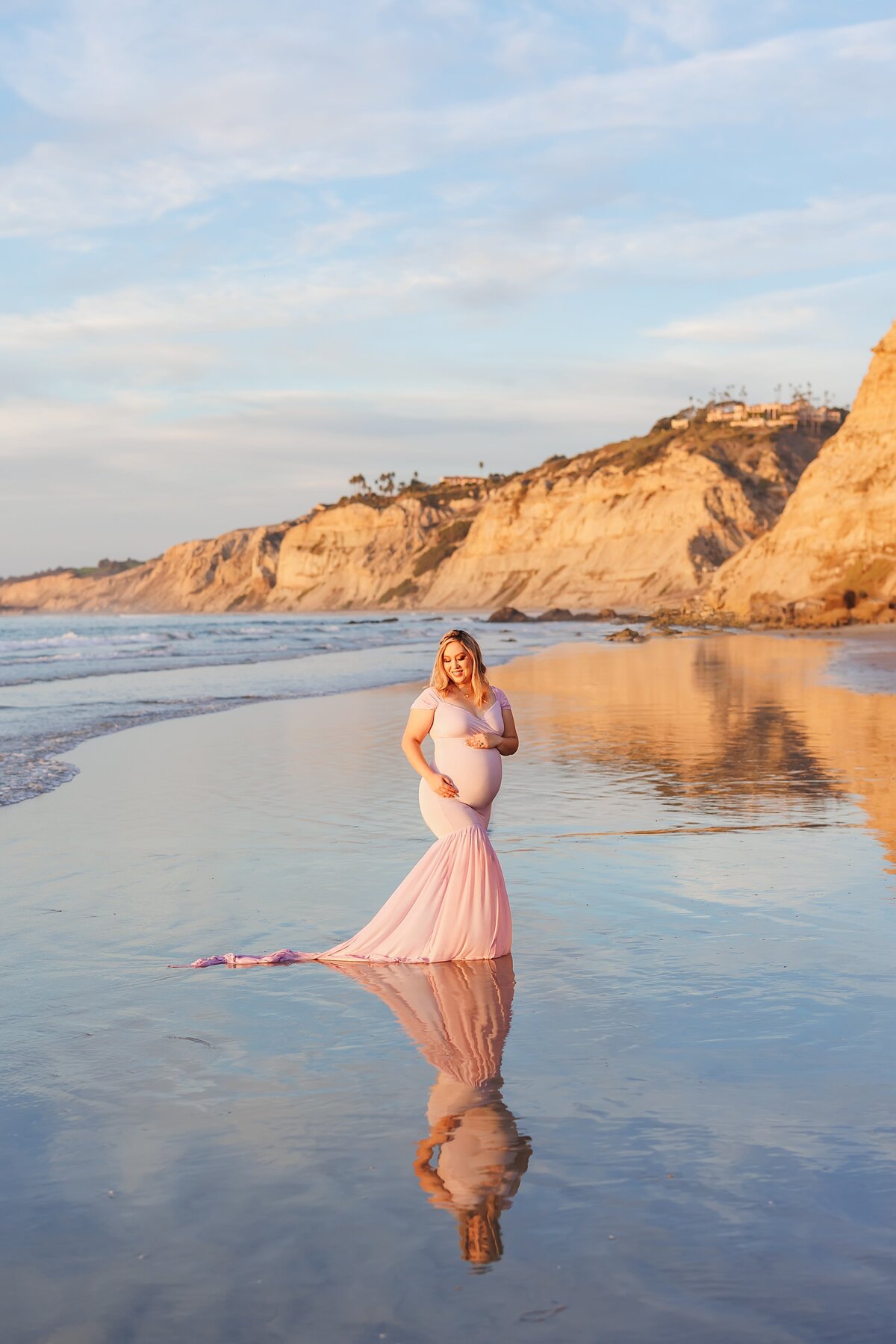 Maternity portrait of woman on the beach in La Jolla with reflection on the wet sand