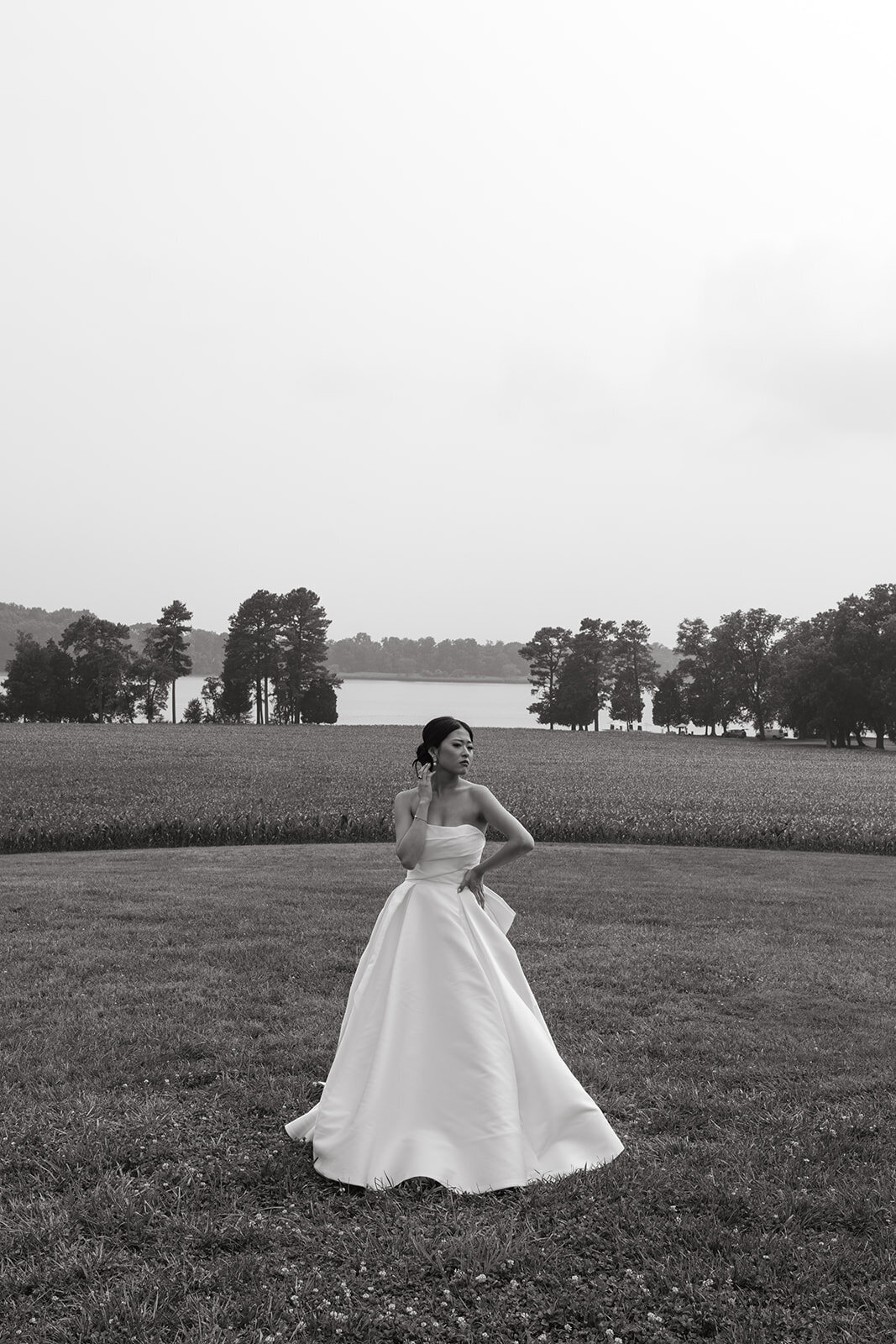 Bride posing in a white dress in a field