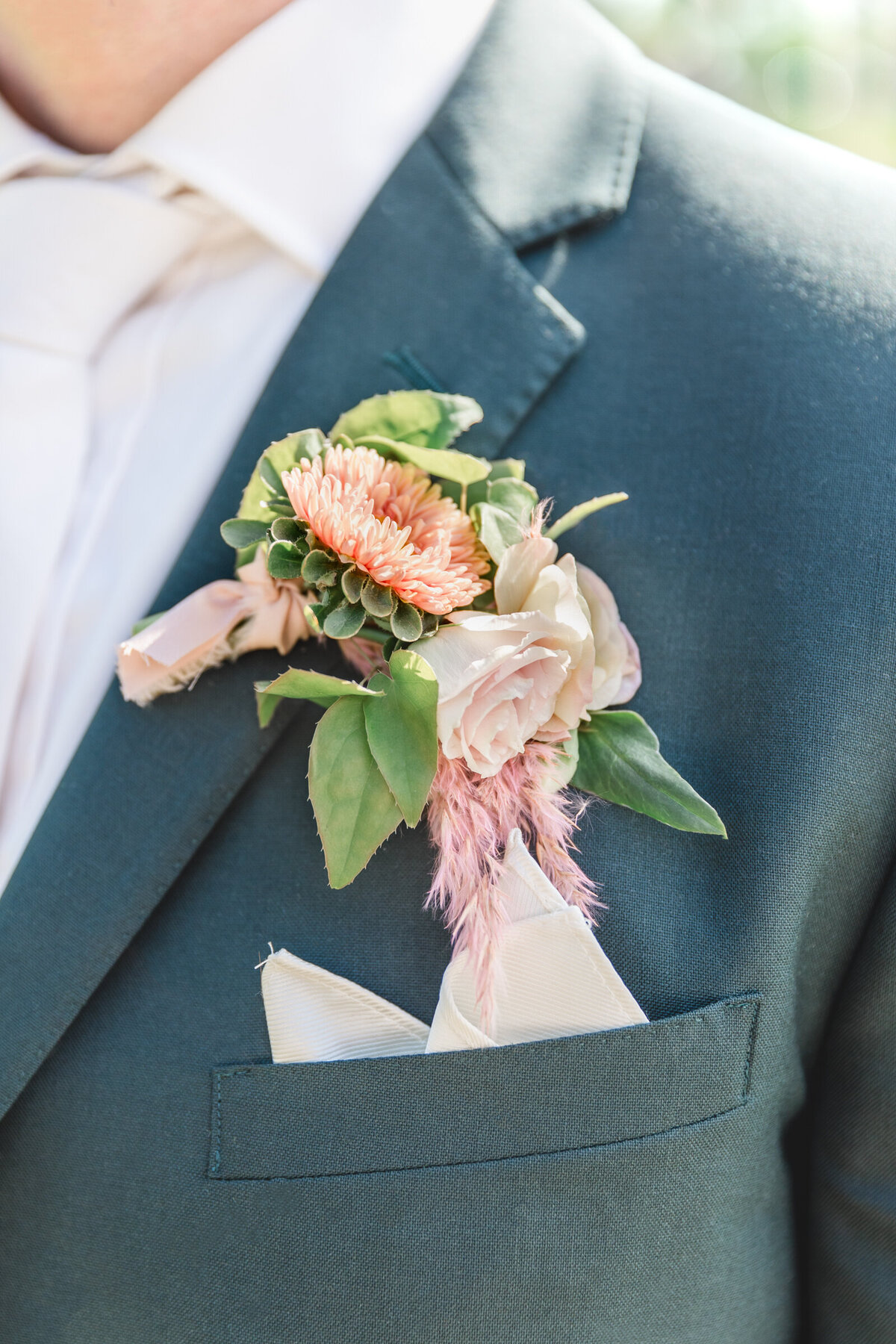 A close up of peach boutonniere
