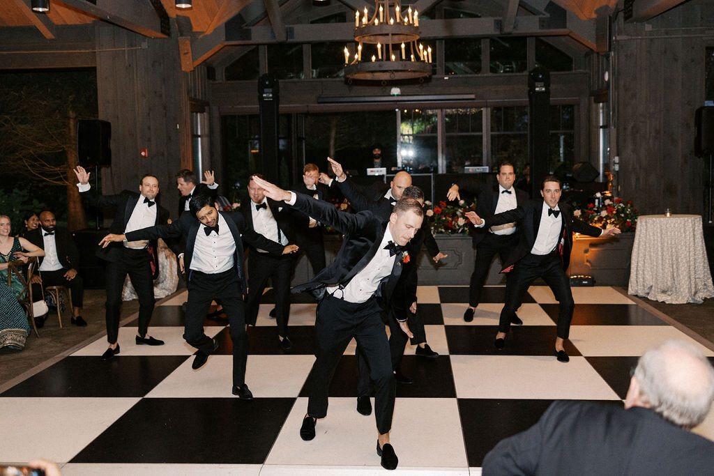 Groom dancing on the wedding reception dance floor surrounded by friends and family in Highlands, North Carolina.
