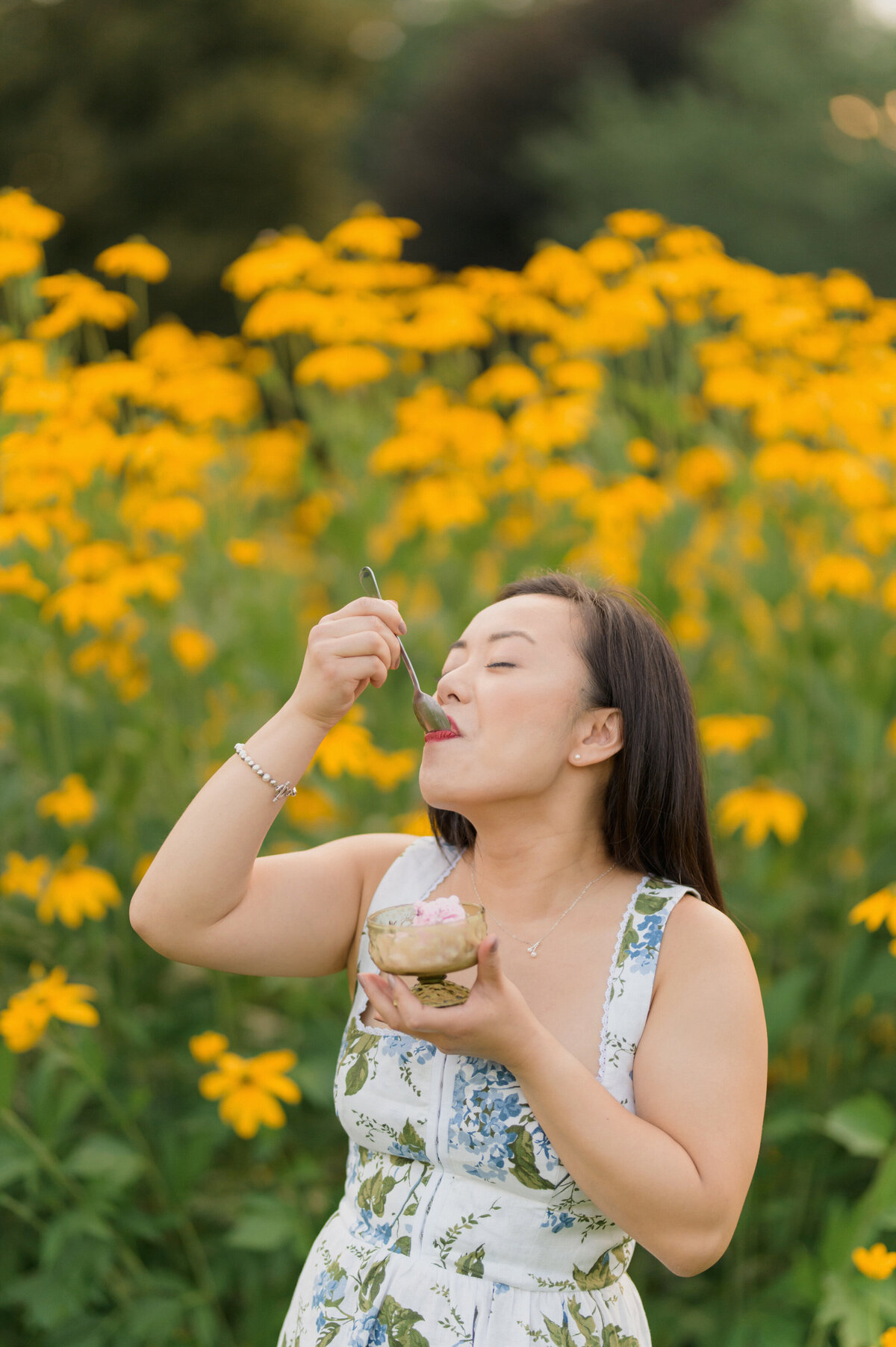 multicultural couple engagement session and a picnic at the park in new england. indain man and asian women eat ice cream and playful portraits.