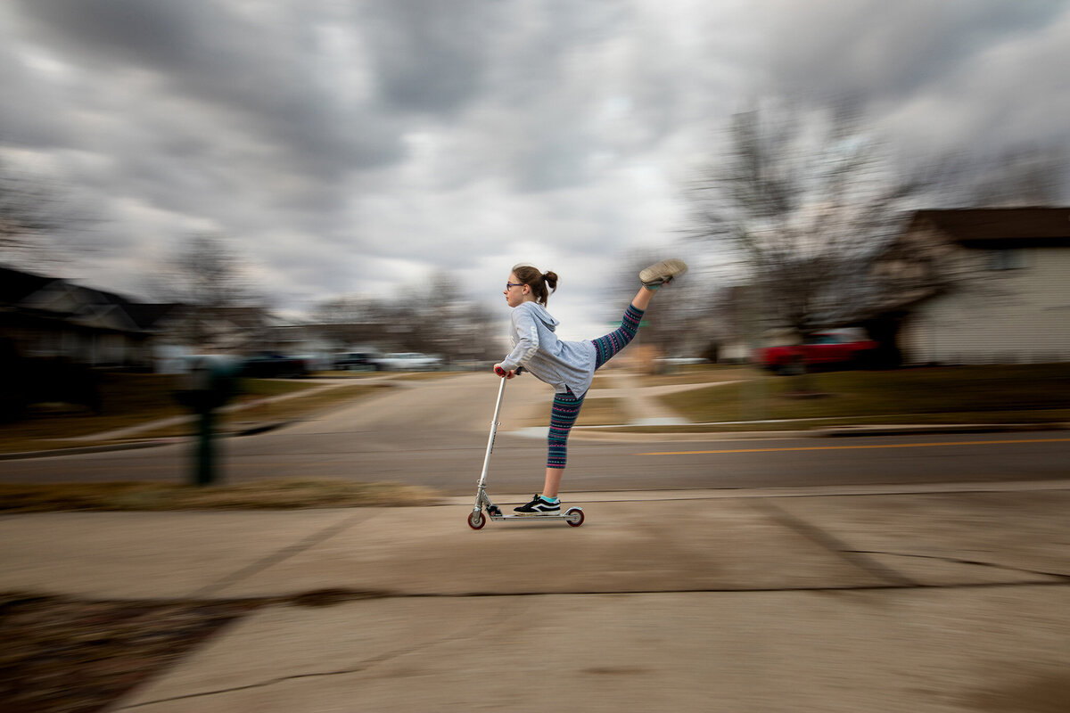 long exposure photo of girl on scooter