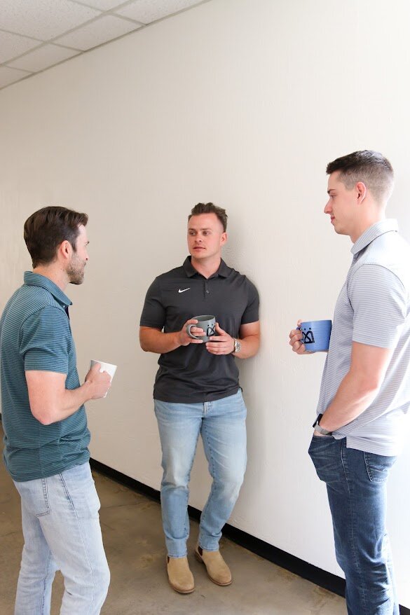 Three men fellowship in hallway- Restoration