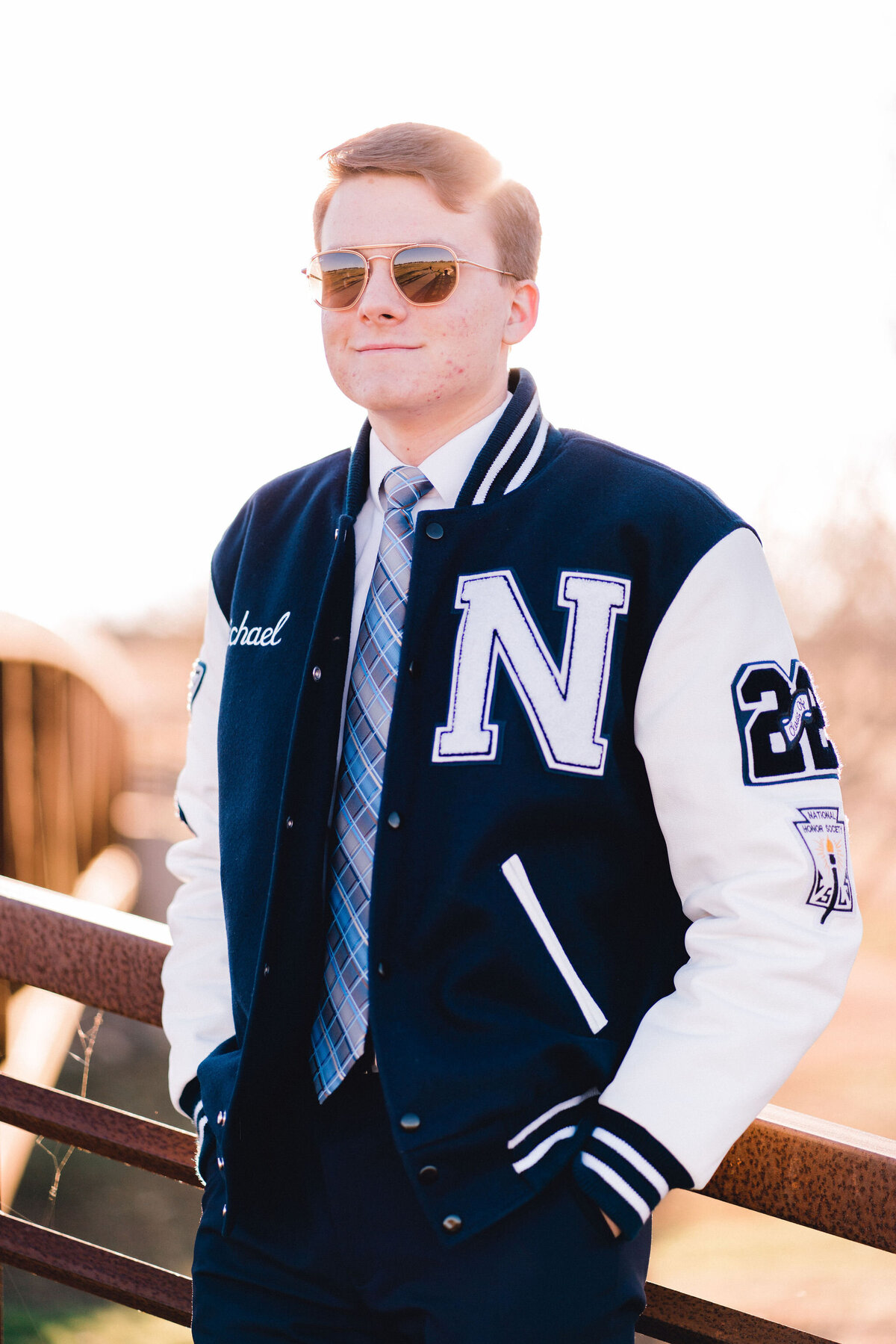 Austin senior boy in letterman jacket. Outside in Austin Texas.