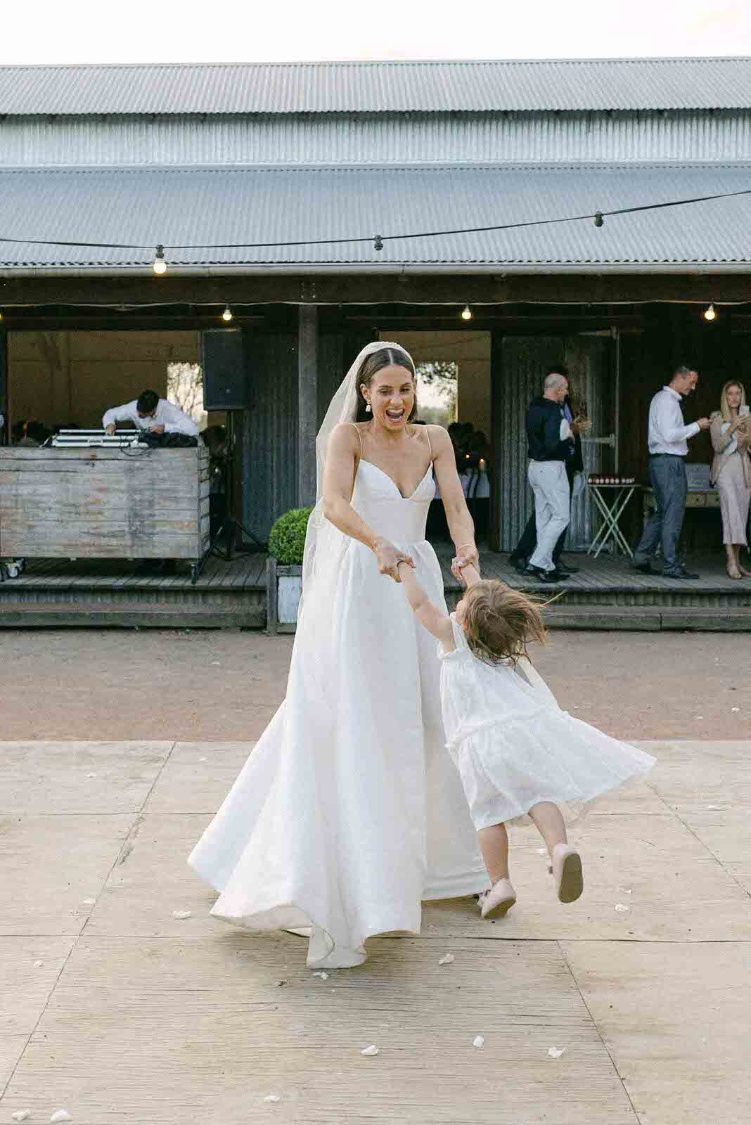 bride dancing with her flower girl