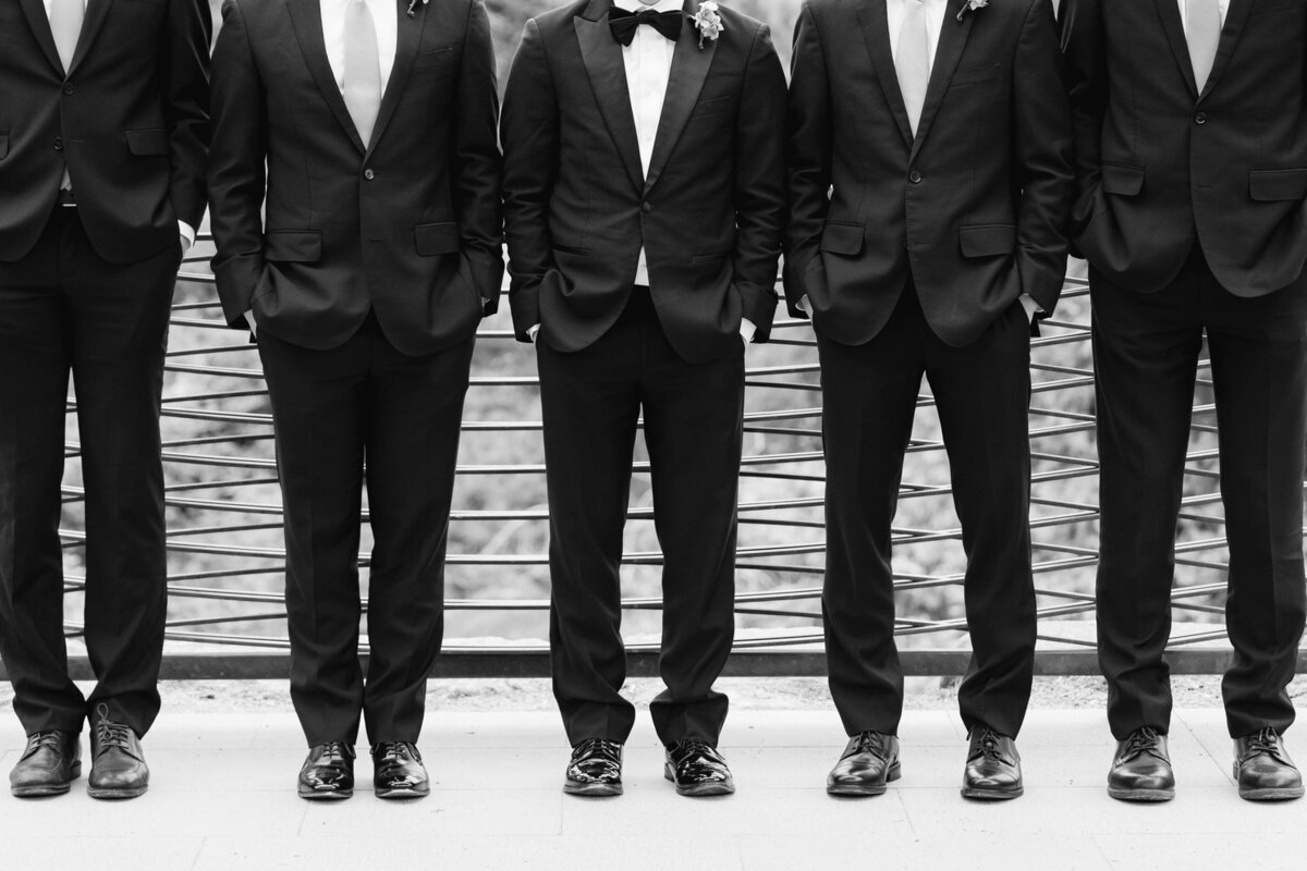 black and white groom and groomsmen lower half documentary style