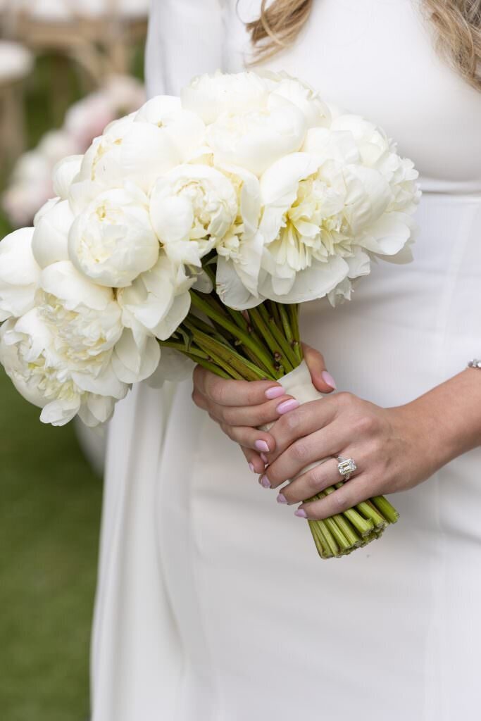 Close up of a woman holding a bouquet of flowers