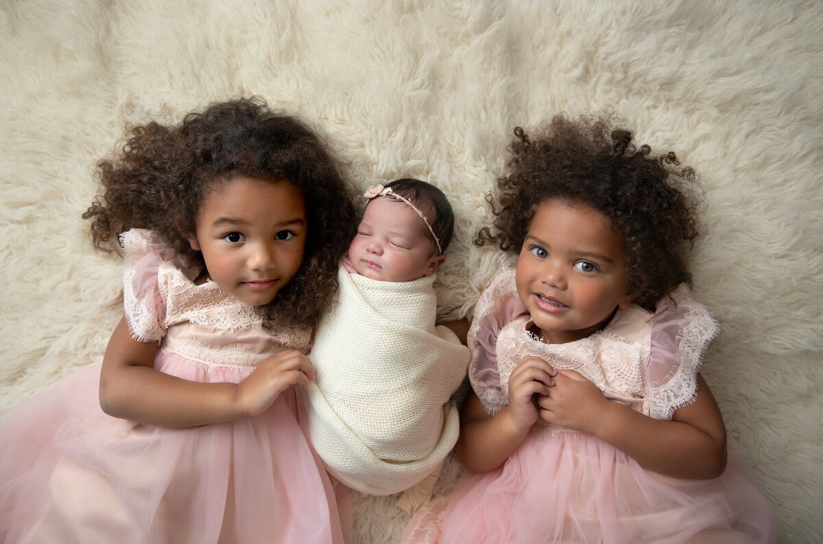 two sisters with newborn sister