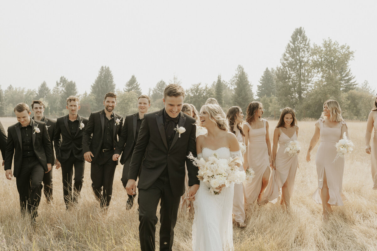 Couple and bridal party walking