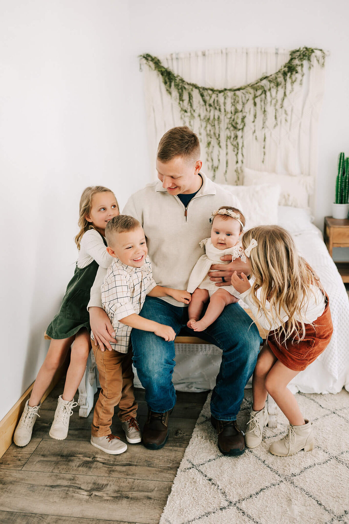 dad playing with kids in family photography studio in Springfield MO