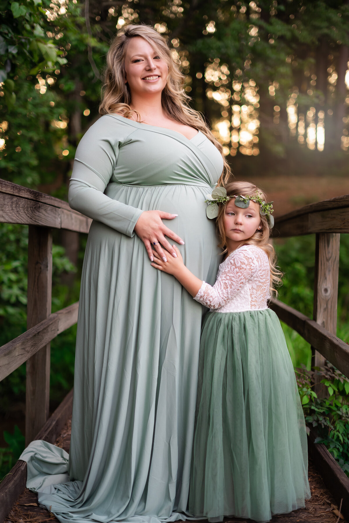 Mother and daughter snuggling maternity pose