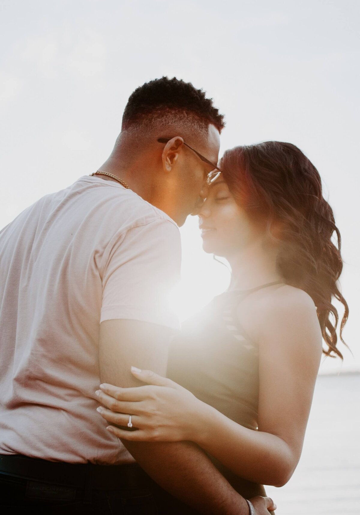 Man Wearing White Shirt Kissing Woman in Her Nose
